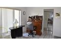 Bright office space with a roll-top desk, white tile floors, and a large window at 5502 Minaret Ct, Orlando, FL 32821