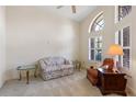 Bright living room with neutral carpet, tall arched window, and comfortable seating arrangement at 58 Golf View Dr, Ocala, FL 34472