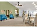 Inviting living area flows into dining area, perfect for entertaining with convenient pass through to kitchen at 6147 Sunnyvale Dr # Ge, Orlando, FL 32822