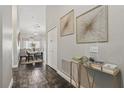 Bright hallway featuring elegant decor, leading to an open-concept dining and living area with stylish accents at 634 Chadbury Way, Kissimmee, FL 34744