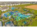 Complete aerial view of the community's amenities, including pools, waterslides, and recreation area at 8991 Fluffy Lie Ct, Davenport, FL 33896