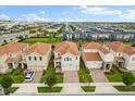 An aerial view of houses showing the manicured lawns, driveways, and uniform architecture in a well-planned community at 8991 Fluffy Lie Ct, Davenport, FL 33896