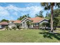 Beautiful single-story home featuring lush green lawns, mature trees, and well-maintained landscaping at 907 Ridge Spring Ct, Apopka, FL 32712