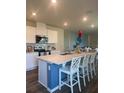 Modern kitchen with a center island, stainless steel appliances, and ample counter space at 987 Commons Way, Port Orange, FL 32129