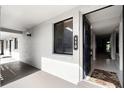 Inviting condo entrance with a dark front door, address number and interior hallway view at 11 Escondido Cir # 110, Altamonte Springs, FL 32701