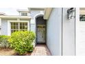 Close-up of front entrance, with an inviting doorway and tiled walkway at 1204 Blackheath Ct, Davenport, FL 33897