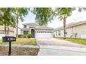 Charming two-story home featuring a brick driveway and well-maintained landscaping at 1204 Blackheath Ct, Davenport, FL 33897