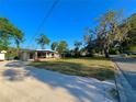 Street view of a house surrounded by a well-maintained lawn and mature trees under a clear blue sky at 1221 Oak Haven Dr, Altamonte Springs, FL 32714