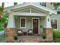 Inviting front porch with comfortable seating and a brick-paved surface at 13 Hill Ave, Orlando, FL 32801