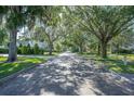Scenic brick-paved street lined with mature trees draped with Spanish moss at 1661 Woodland Ave, Winter Park, FL 32789