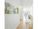 Hallway with white walls and trim with lots of natural light at 1845 Common Way Rd # 28-206, Orlando, FL 32814