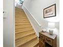 Bright staircase with wooden steps and white railing at 1845 Common Way Rd # 28-206, Orlando, FL 32814