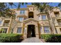 Attractive condo exterior with manicured shrubs and access to multiple units at 305 Terrace Ridge Cir # 305, Davenport, FL 33896