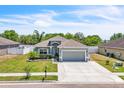 Inviting single-story home with a well-kept lawn, neutral exterior, and a spacious two-car garage at 344 Highland Meadows St, Davenport, FL 33837
