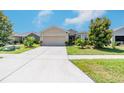 Inviting single-Gathering home boasting a large driveway and a neatly landscaped front yard at 3679 Julius Estates Blvd, Winter Haven, FL 33881