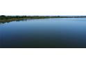 Expansive view of the calm, shimmering lake under a clear sky, showcasing peaceful scenery at 3679 Julius Estates Blvd, Winter Haven, FL 33881