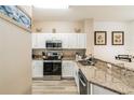 Bright kitchen featuring white cabinets, granite countertops, and stainless steel appliances at 4504 Alberto Cir, Kissimmee, FL 34746