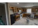 Partially renovated kitchen featuring a window, exposed cabinets and appliances ready for your design vision at 459 Danube Dr, Poinciana, FL 34759