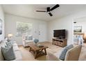 Bright living room with neutral tones, comfortable seating, and view into main bedroom at 730 Georgia Ave, Longwood, FL 32750