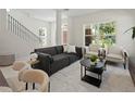 Sun-filled living room with neutral tones, modern furniture, and large windows offering natural light at 805 S Locust Ave, Sanford, FL 32771