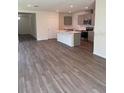 Open floor plan showcasing a modern kitchen with an island and stainless steel appliances at 978 Commons Way, Port Orange, FL 32129