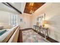 Bright foyer boasts stylish decor, wood-look floors, shiplap walls, and a decorative ceiling at 984 Fern Ave, Orlando, FL 32814