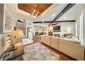 Spacious living room with beamed ceilings, shiplap walls, fireplace, and wood floors at 984 Fern Ave, Orlando, FL 32814