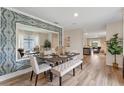 Elegant dining area with a large decorative mirror and stylish furniture at 989 Commons Way, Port Orange, FL 32129