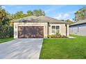 Inviting single-Gathering home with a lush lawn, long driveway, and attached garage at 104 Alta Vista Way, Davenport, FL 33837