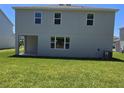 Expansive backyard with lush lawn, featuring a covered patio, perfect for outdoor enjoyment at 1169 Happy Forest Loop, Deland, FL 32720