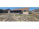 Spacious backyard featuring a screened porch, a small patio area, and partial fencing at 129 Valentino Ct, Davenport, FL 33837