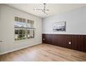 Bedroom boasting wood floors, a large window, and modern wall accents at 13242 Orange Isle Dr, Windermere, FL 34786