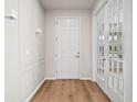 Bright entryway featuring wood floors, interior door and glass paned french doors at 13242 Orange Isle Dr, Windermere, FL 34786