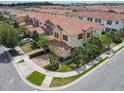 Beautiful aerial view of a townhome with red shutters and tropical landscaping in a residential neighborhood at 14014 Millington St, Orlando, FL 32832
