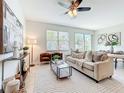 Bright living room with neutral decor, stylish furniture, and large windows that let in natural light at 14014 Millington St, Orlando, FL 32832
