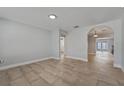Bright living room featuring neutral paint, tile floors, and arched doorway at 145 Burns Ave, Longwood, FL 32750