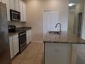 Modern kitchen featuring stainless steel appliances and granite countertops at 14867 Driftwater Dr, Winter Garden, FL 34787