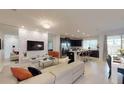 Open-concept living area featuring a decorative wall, modern furnishings, and a seamless flow to the kitchen at 1569 Carey Palm Cir, Kissimmee, FL 34747