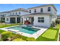 Outdoor oasis boasting a private pool, putting green, covered patio, and lush landscaping for ultimate relaxation at 15727 Vetta Dr, Montverde, FL 34756