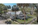 Aerial view showcases the property's fenced yard, mature trees, and appealing architectural style at 246 N Oak Ave, Orange City, FL 32763