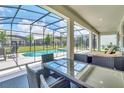 Covered patio with outdoor seating and a view of the pool and backyard at 2616 Calistoga Ave, Kissimmee, FL 34741