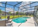 Backyard features a private screened-in pool with an attached jacuzzi and ample space at 2616 Calistoga Ave, Kissimmee, FL 34741