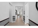 Hallway with decorative molding, neutral paint scheme and views into the living area at 2741 Serenity Meadow Dr, Kissimmee, FL 34744