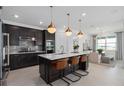 Beautiful kitchen with island seating, pendant lights, and stainless steel appliances at 2741 Serenity Meadow Dr, Kissimmee, FL 34744