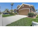 Exterior view showcasing the front yard, driveway, and two-car garage at 2827 Moonstone Bnd, Kissimmee, FL 34758