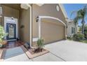 Exterior of home with a two-car garage and tiled front porch at 2827 Moonstone Bnd, Kissimmee, FL 34758