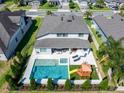 Aerial view of in-ground pool, hot tub, and backyard play area in fenced backyard at 327 Island Sound Ct, Longwood, FL 32779