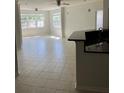 Bright living room featuring tile floors, ceiling fans, and large windows at 3344 Corona Village Way # 205, Orlando, FL 32835