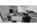 Kitchen featuring white cabinets, granite counters, stainless steel appliances and tile floors at 3379 S Kirkman Rd # 1015, Orlando, FL 32811