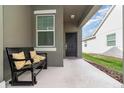 Inviting front porch with a cozy bench and decorative pillows near the main entry at 3443 Sagebrush St, Harmony, FL 34773